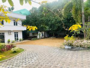 a brick driveway in front of a house at Hotel Sojan in Veyangoda