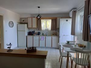 プレベザにあるCozy studio in Pantokratorasのキッチン(テーブル、冷蔵庫付)、ダイニングルームが備わります。