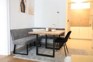 a dining room table and chairs in a room at City apartment with charm in Tulln +5 photos
