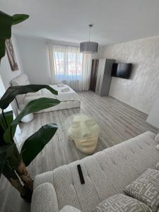 a living room with a couch and a table at Daly Residence in Buzau