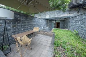 a patio with a table and chairs and an umbrella at 沁住酒店重庆南坪万达广场店 in Chongqing