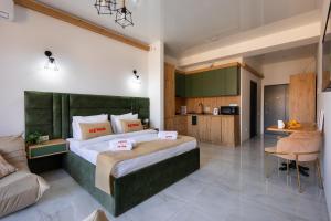 a bedroom with a large bed and a kitchen at Studio KeyGo #0058 near the Ararat Museum in Yerevan