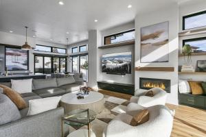 a living room with a couch and a fireplace at 1506 W Orion Way - SkyRidge 6 BR Home with Hot Tub home in Keetley