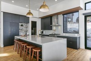 a kitchen with a large island with bar stools at 1506 W Orion Way - SkyRidge 6 BR Home with Hot Tub home in Keetley +40 photos