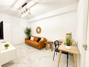 a living room with a couch and a table at Oasis Beach Home Meloneras with jacuzzi in Maspalomas