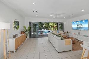 a living room with a couch and a table at Golden Beach Oasis - Sleeps 12 in Golden Beach