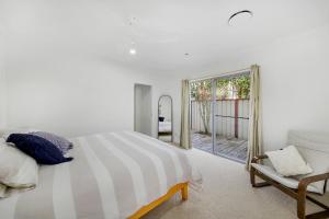 a bedroom with a bed and a chair and a window at Golden Beach Oasis - Sleeps 12 in Golden Beach +24 photos