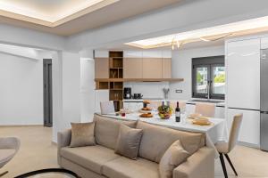 a living room and kitchen with a couch and a table at Casa De Sario in Rhodes Town