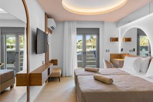 a hotel room with a large bed and a desk at Casa De Sario in Rhodes Town