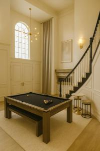 a living room with a pool table and stairs at Santa Monica Beach Retreat with Hot Tub, Billiards & Grill in Los Angeles