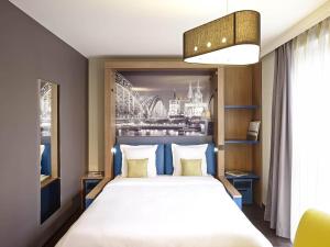 Ένα ή περισσότερα κρεβάτια σε δωμάτιο στο Aparthotel Adagio Köln City