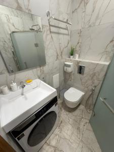 a bathroom with a white sink and a toilet at Borytchyw in Kyiv