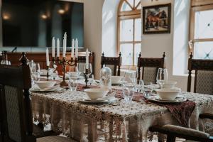 a table with a white table cloth and candles on it at Villa Serena in Siklós
