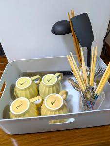 a container filled with chopsticks and chopsticksinders at Moon Rising 102 in Takatsu-ku