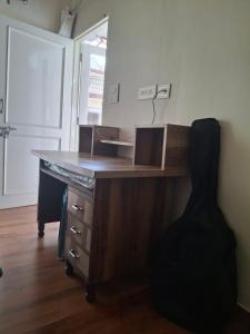 a wooden desk in a room with a door at Sunrise Villa in Kharar