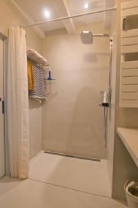 a shower with a glass door in a bathroom at Rénovation d'Architecte- Mer &Phare à pied in Saint-Clément-des-Baleines