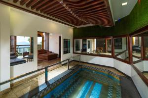 an indoor swimming pool in a house at Parakkat Nature Resort in Munnar