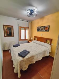 a bedroom with a bed with two towels on it at CASA RURAL EL CAIDERÓN in Ambel