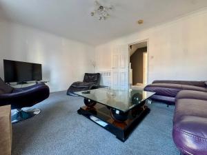 a living room with a couch and a glass table at Jessie Terrace Stays in Southampton