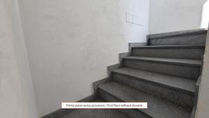 a staircase in a building with a sign that says first floor within cluster at Sugheri di mare - By Ligooria in Pietra Ligure