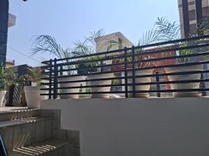 a balcony with a black fence and some plants at Sunrise Villa in Kharar