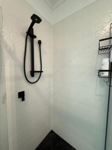 a bathroom with a shower with a shower head at Paradise Retreat in Tauranga +30 photos