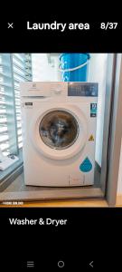 a washer and dryer sitting in a room at Eaton kl,1R1B,0 Servies,500 mbps,klcc,2 pax in Kuala Lumpur