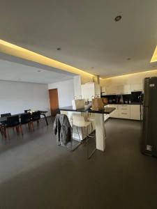 a kitchen and dining room with a table and chairs at 3 bedroom seafront apartment in Limassol