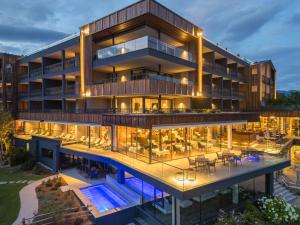 an aerial view of a building with tables and chairs at SONNENBERG Panorama Dolomites Wellbeing in Maranza
