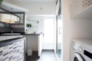 a small kitchen with a sink and a washing machine at Monza-Center, Modern Apartment in Monza +13 photos