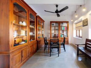a dining room with wooden cabinets and a table and chairs at Serendipity in Colombo