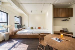 Un dormitorio con una cama y una mesa de madera. en The Amethyst Nest Hanoi-Tranquil Stay with Rooftop & Coffee Shop-Near Old Quarter, en Hanói 138 fotos más