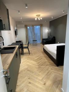 a bedroom with a bed and a kitchen with a table at Ayia Napa 1 Studio in Ayia Napa +6 photos