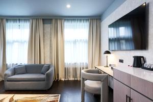 a living room with a couch and a chair and a table at Pullman Riga Old Town - Renovated 2025 in Rīga