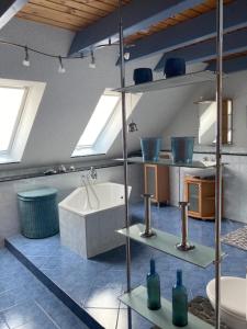 a bathroom with a sink and a toilet and a tub at Pension zum Yachthafen in Waren +48 photos