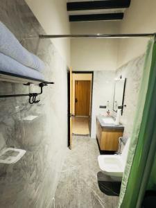 a bathroom with two sinks and a mirror at Sahyadri Farms agro tourism-Villa and cottages 