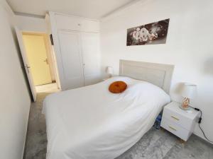 a white bedroom with a pumpkin on a bed at Mas de Tanit Appartement & Vacance deLuxe in Antibes