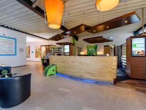 a restaurant with a wooden counter in a room at ibis Styles Leipzig in Radefeld +118 photos