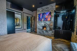 a bedroom with a bed and a stone wall at Brierley Club Hideaway Chic 7 Star Retreat in Rishton