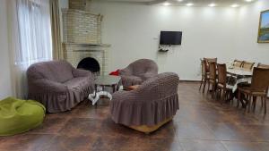 a living room with two chairs and a fireplace at Mon Ami Tsaghkadzor in Tsaghkadzor