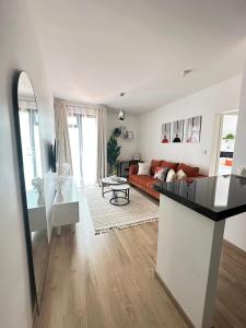 a living room with a couch and a table at Dream Nook - One Bedroom Apt in Tatu City in Tatu City