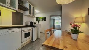 a kitchen with a wooden table and a dining room at Wohnung 1 Altstadt in Ulm