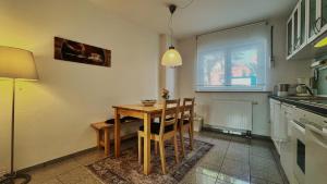 a kitchen with a table and chairs in a room at Wohnung 1 Altstadt in Ulm