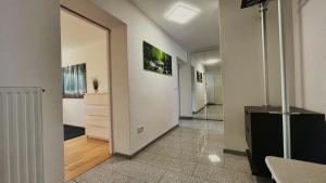 a hallway with white walls and a hallway with a mirror at Wohnung 1 Altstadt in Ulm +2 photos