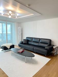 クリにあるDodi's 3room APTのリビングルーム(黒い革張りのソファ、テーブル付)