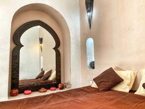 a bedroom with a large mirror on the wall at Top Riad 6 persons 5 minutes main square in Marrakech