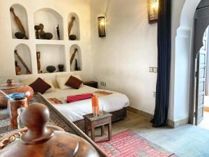 a hotel room with a bed and a table at Top Riad 6 persons 5 minutes main square in Marrakech