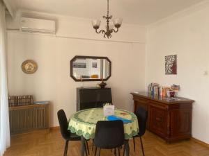 a dining room with a table with chairs and a mirror at SEAVIEW KAVALA PORT in Kavála