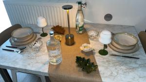 a table with a bottle and glasses and candles on it at Nouveau - Oasis et Havre de Paix proche du Centre De Nancy in Nancy