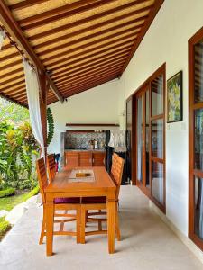 a wooden dining table and chairs in a room at Good Karma House Ubud in Ubud +32 photos